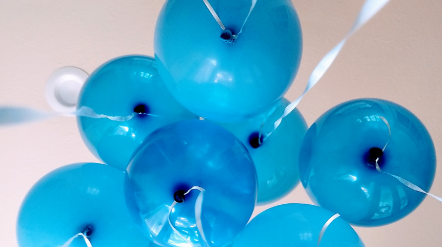 Bottoms of blue balloons in the air