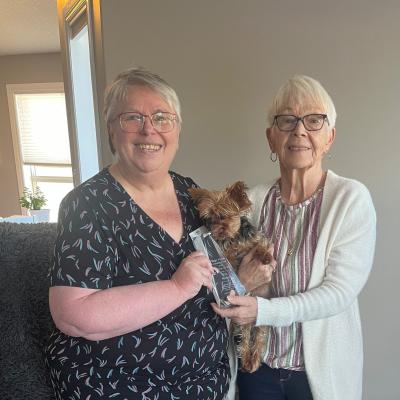 Picture of Barb (Society staff member) and Chris Nelson (award recipient) holding award.