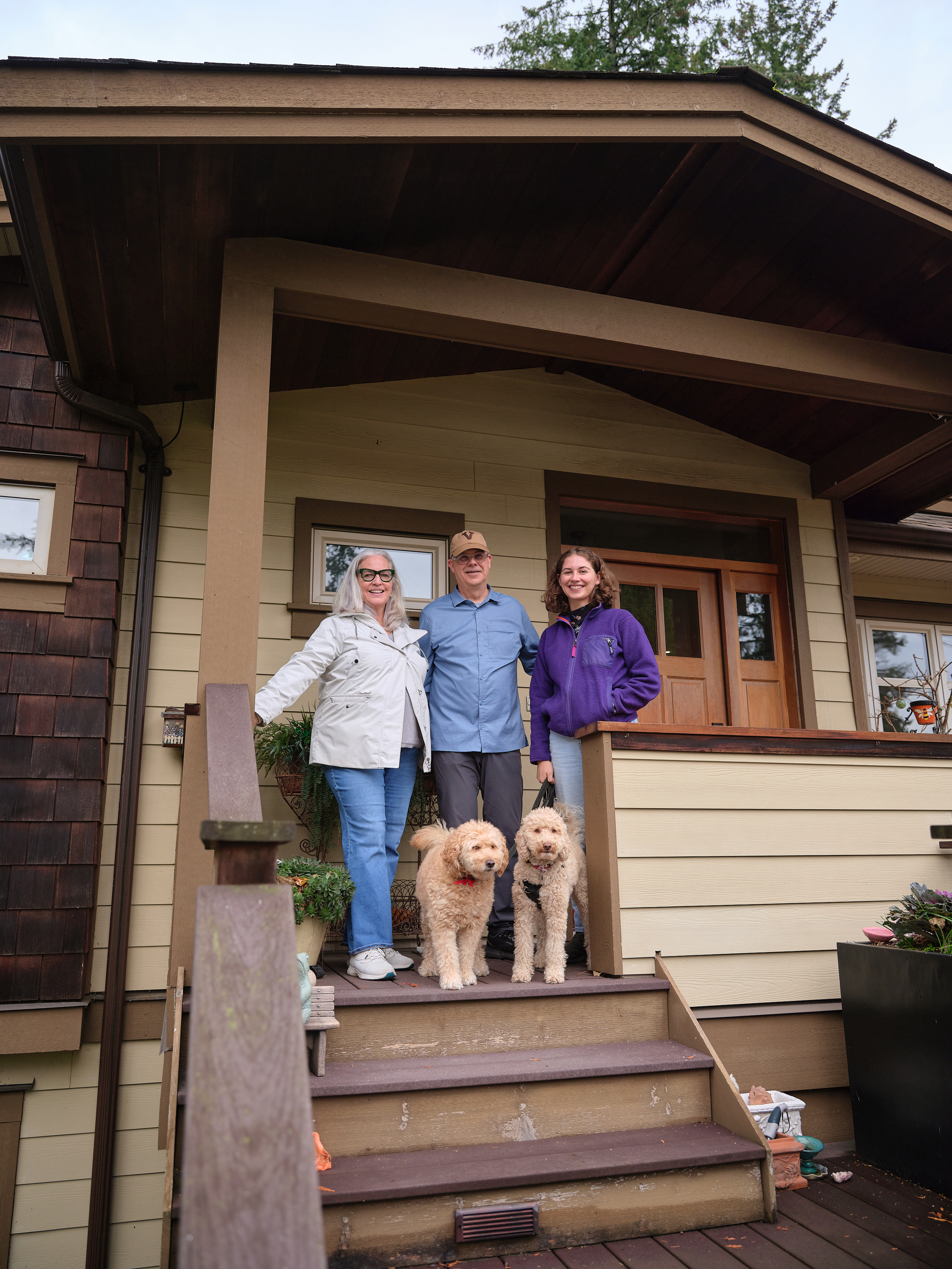 Erin and Geoffrey at home with their daughter, Olivia, and their two dogs Kula and Coco.