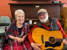 Janet pictured next to her husband, Terry, who is holding a guitar.