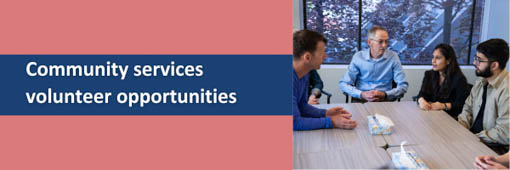 Four diverse people sit around a wooden table in a bright office, engaged in a discussion, with text to the left reading community services volunteer opportunities.