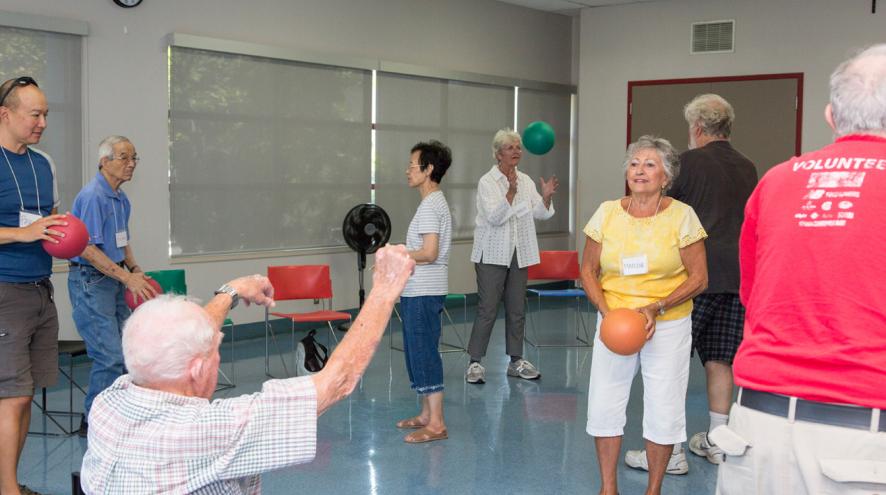 People playing with balls during the fitness portion of a Minds in Motion session.
