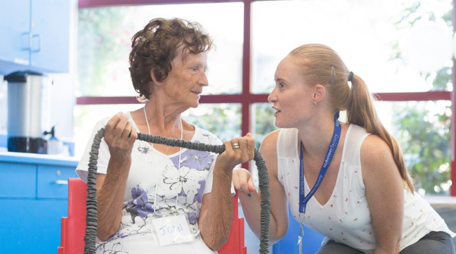 A woman chatting and supporting another woman during a Minds in Motion session.