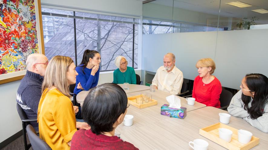 Family members gathered round a table at a support group.