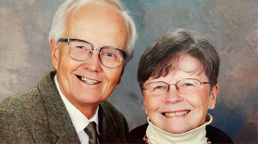 man and wife smiling together looking into camera 