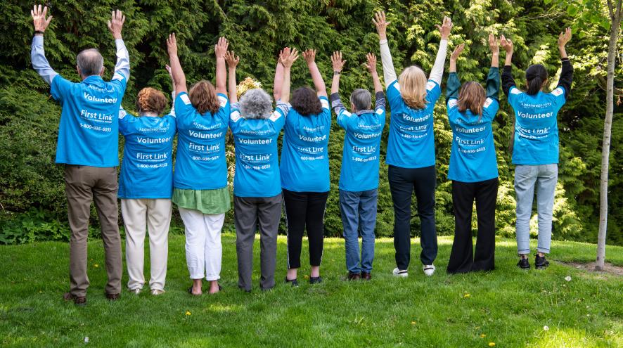 photo of volunteers holding hands up