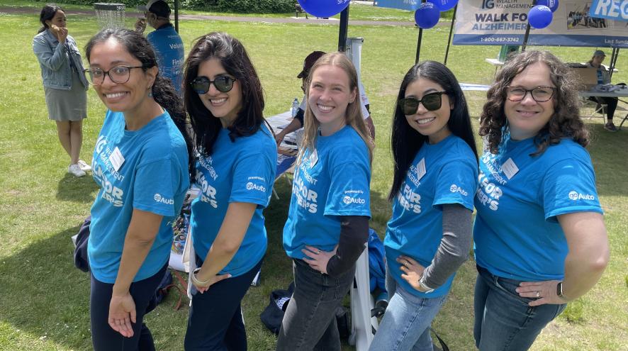 Five people in Walk for Alzheimer's t-shirts displaying the GoAuto logo on the sleeve