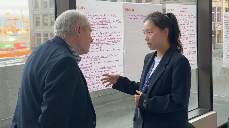 Grace Lee attending the Alzheimer Society of BC's research luncheon and speaking with a lived experience partner.