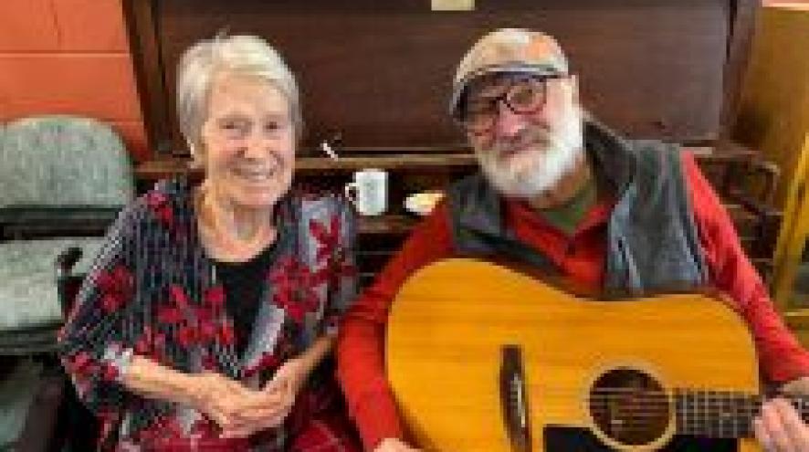 Janet pictured next to her husband, Terry, who is holding a guitar.