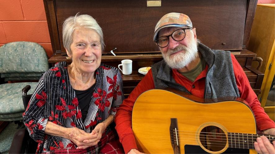 Janet pictured next to her husband, Terry, who is holding a guitar.