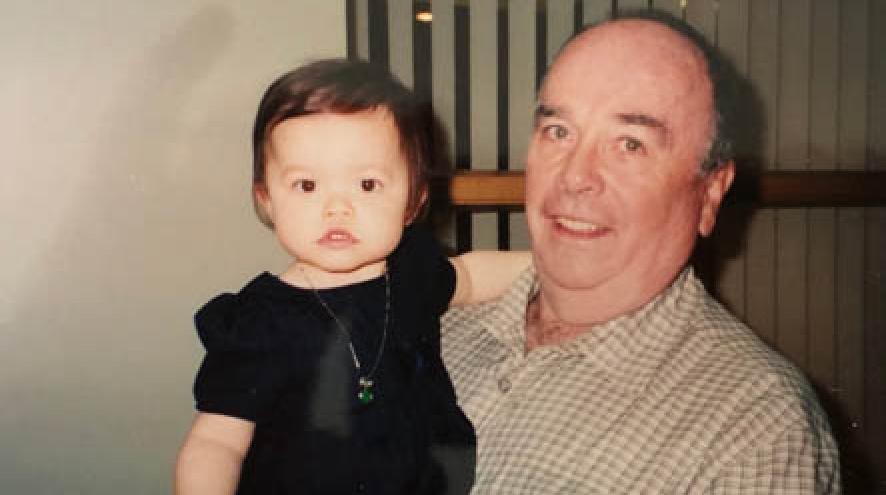 A happy grandfather holds his baby granddaughter 