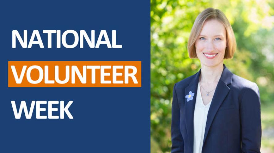 Graphic for National Volunteer Week featuring a smiling woman outside in a navy blue blazer with a forget me not pin