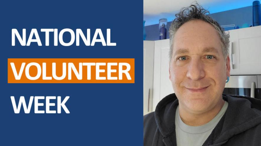 National Volunteer Week promotion with a man standing inside smiling 