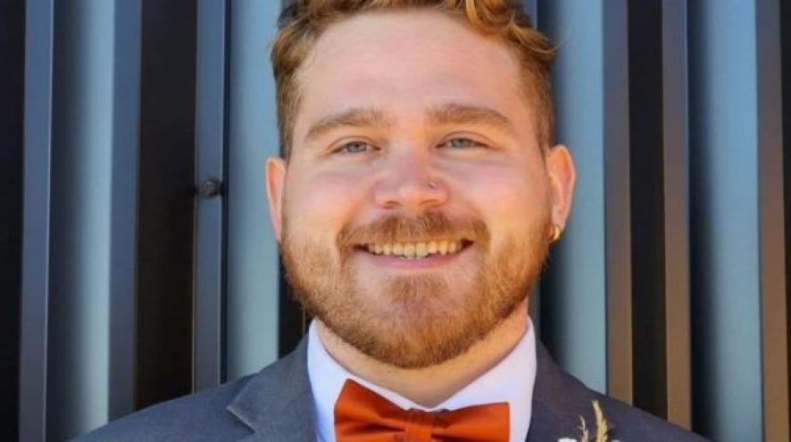 Headshot of volunteer James Donnovan.He is seen smiling and wearing a formal suit.