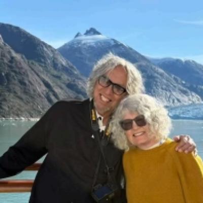 Tobias and Martha standing in front of water and mountains