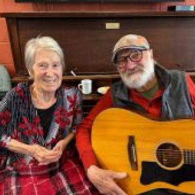 Janet pictured next to her husband, Terry, who is holding a guitar.