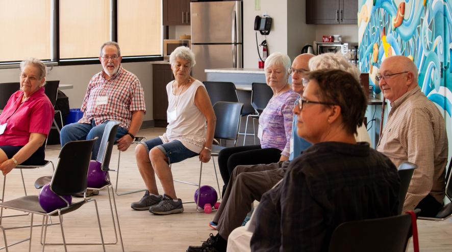 Persons living with dementia and their care partners take part in a Minds in Motion class
