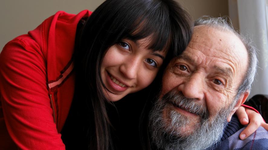 Young woman and older man hugging