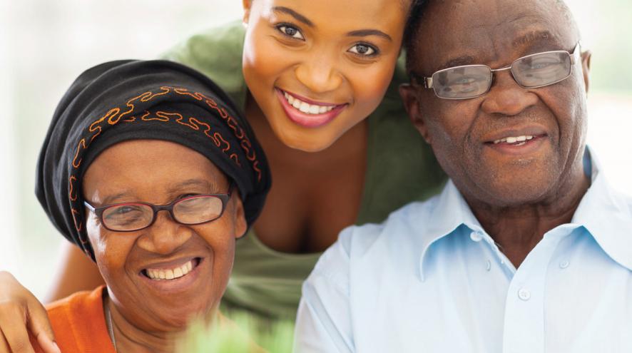 Family of colour smiling with Alzheimer Society of Durham Region logo and April to June 2021 program guide information