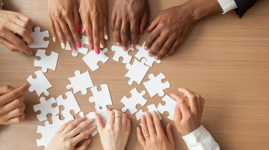 A circle of diverse hands putting together a white puzzle. Text reads Durham Region needs Dementia Champions
