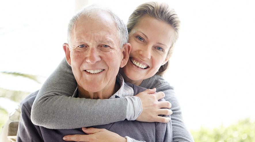 Father and daughter smiling.