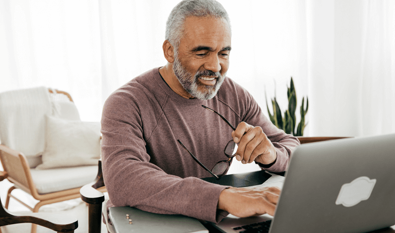 An old man using a laptop