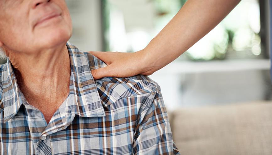 Senior man reassured by helping hand.