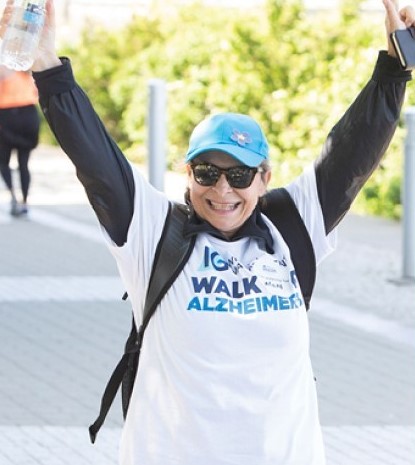 Women raising her hands in celebration at the IG Wealth Management Walk for Alzheimer's.