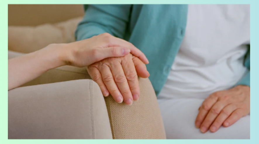 care partner holding hand of loved one