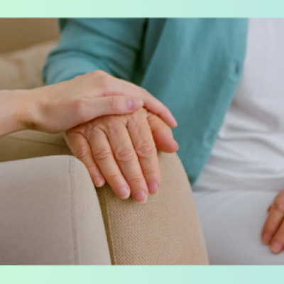 care partner holding hand of loved one
