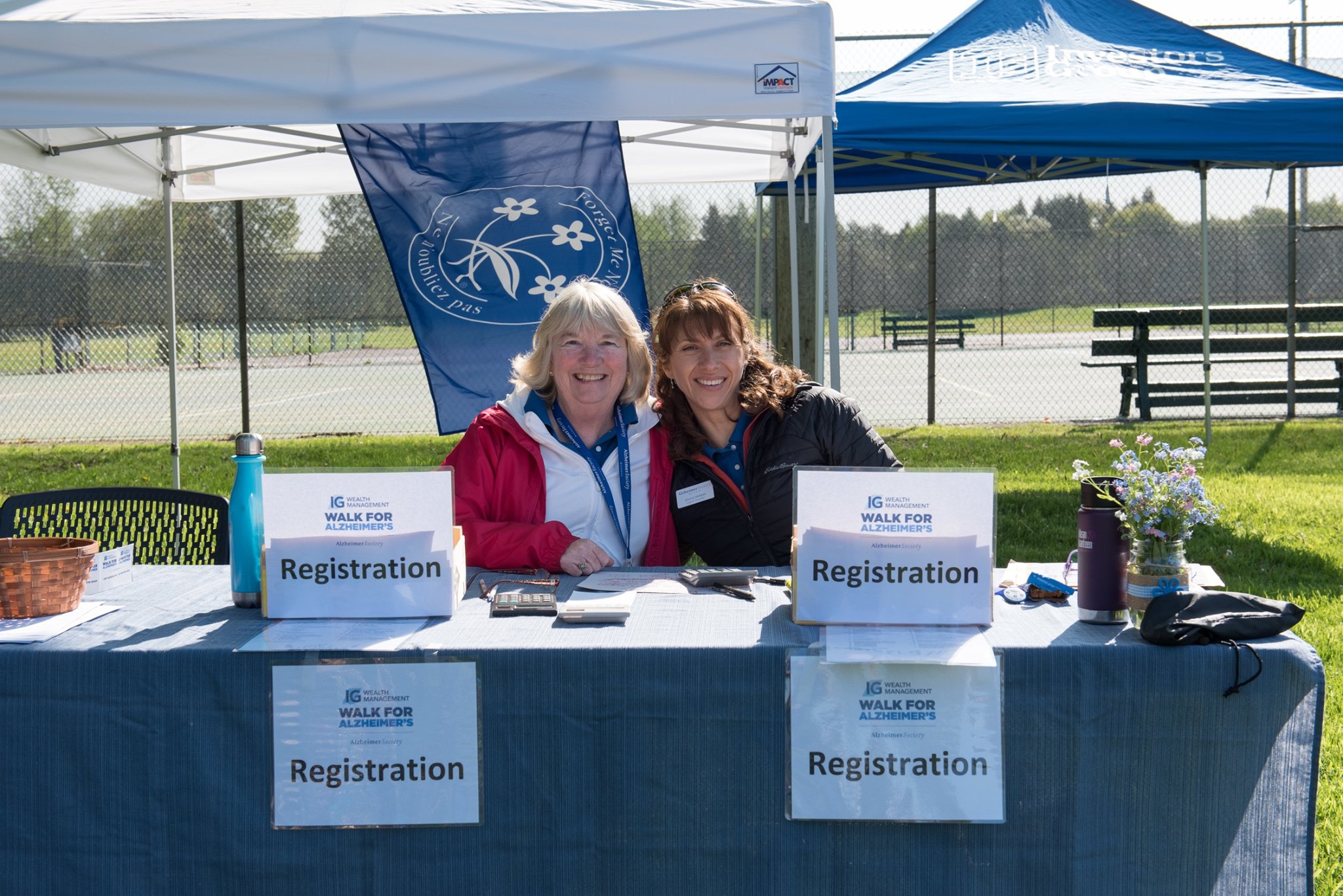 Two Volunteers In A Booth