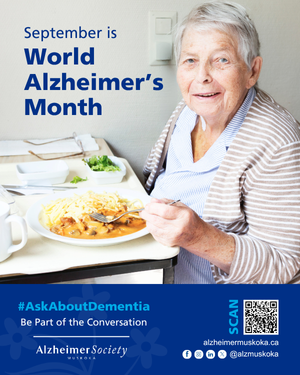 a senior woman sitting in front of a plate of food and smiling at the camera