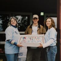 Roger Macdiarmid with Alzheimer Society staff and a birthday cake