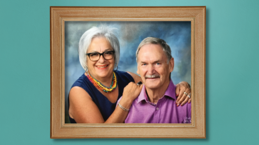 A photo of Martine and Gérard in a wooden frame hanging on a teal wall.