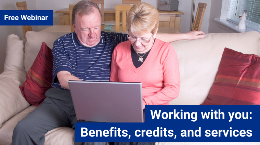 Man and woman on couch using laptop