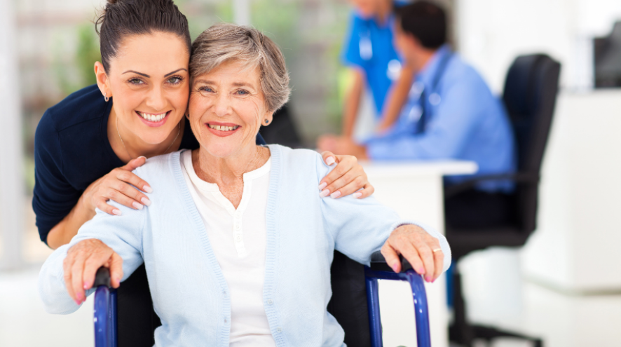 Nurse smiling with patient in wheelchair