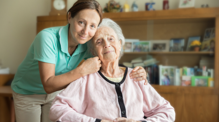 Care worker embracing a senior woman