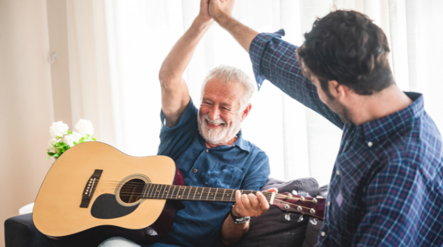 2 men playing the guitar