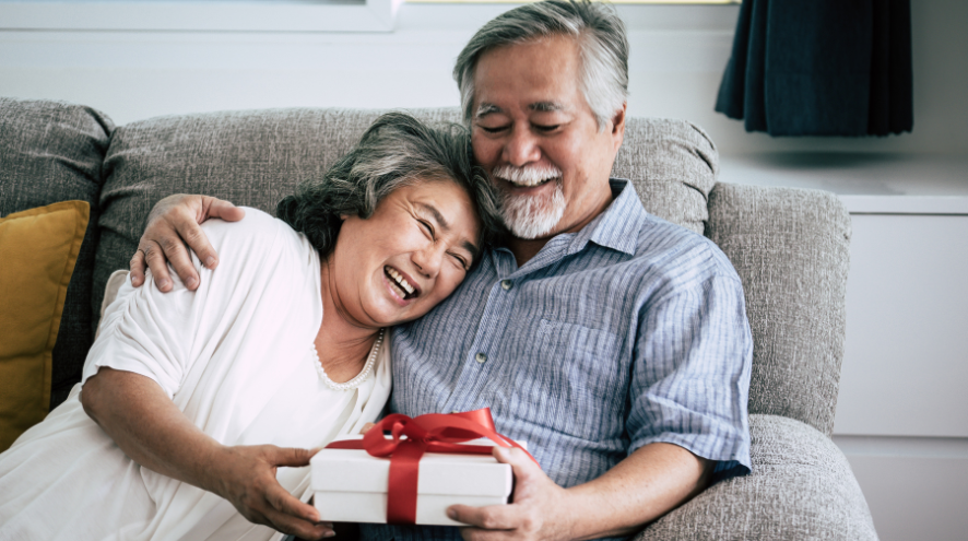 Asian couple holding a present