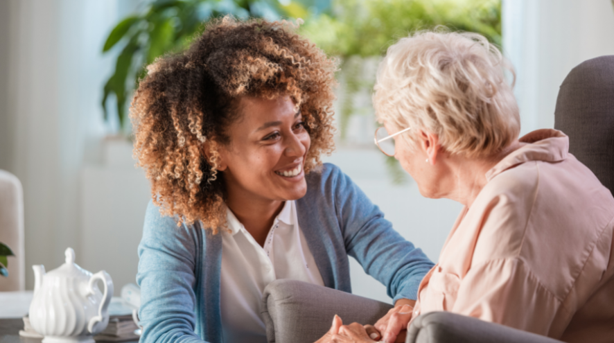 Young woman smiling at elderly woman