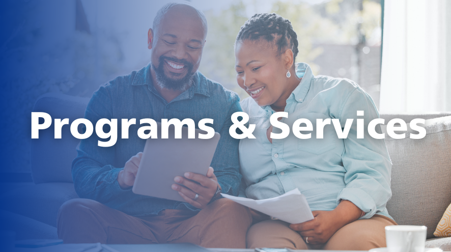 A bearded man holds a tablet in his hands while a woman looks over his shoulder. They are both seated on a couch and smiling. Overset text reads "Programs and services."