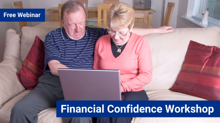 An older man wearing a striped tshirt and a woman wearing a long sleeve coral shirt with short blond hair sit together on a white couch while looking at a laptop.