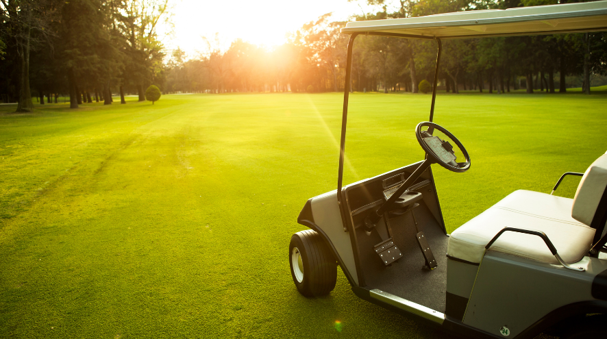 Golf cart on sunny golf green