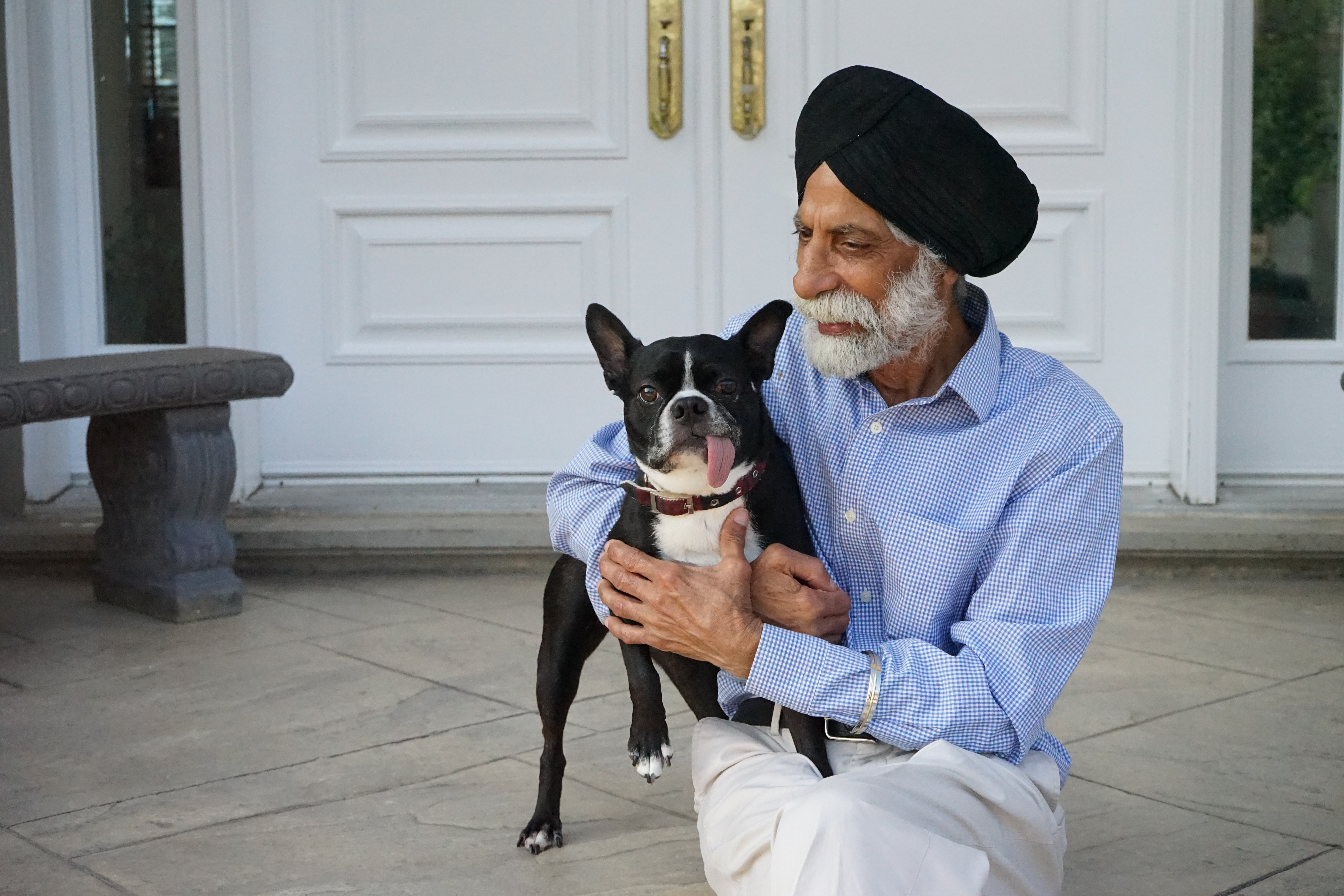 A photo of Jessica's father holding their dog.