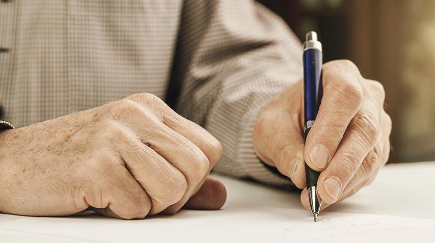 Senior writing a note