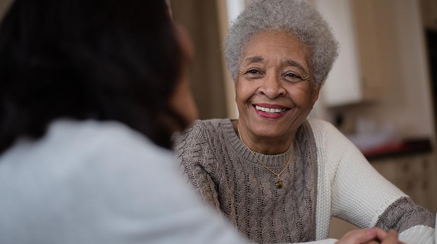 Smiling senior woman talking to her doctor