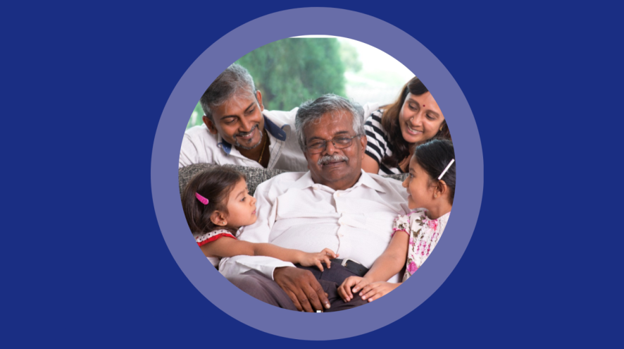 A South Asian family gathered around an elderly man