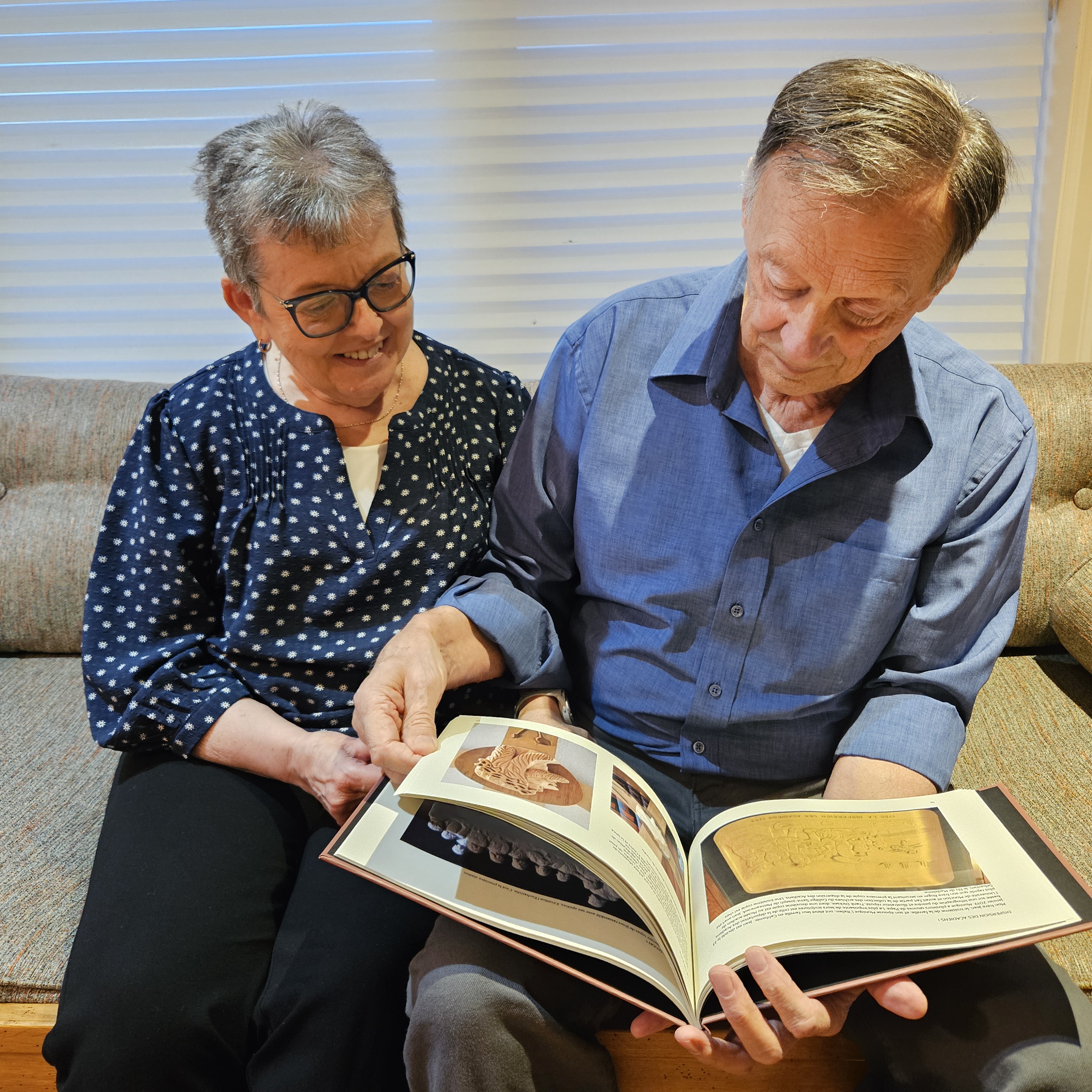 Claudette and Theo looking through photobook