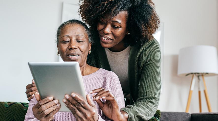 mother and daughter using a tablet together