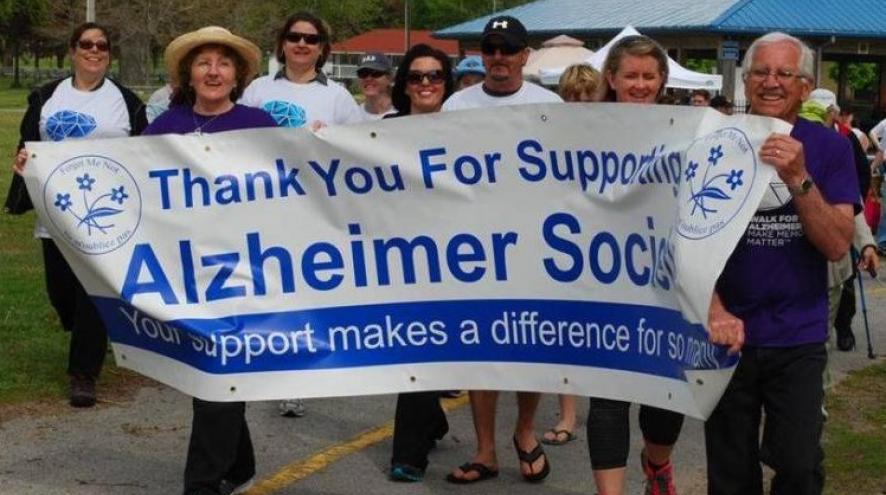 People holding a banner at the Walk for Alzheimer's
